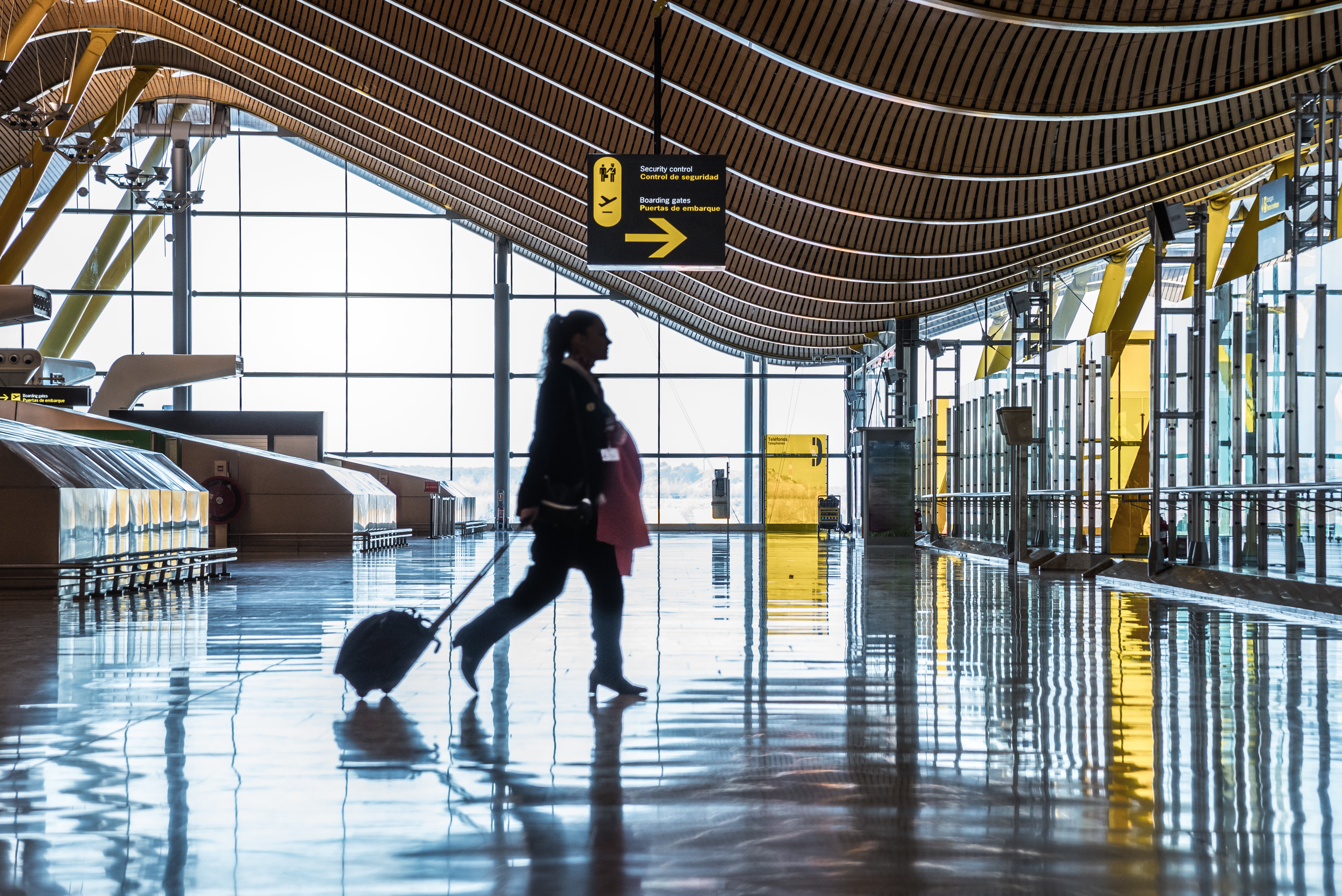 airport terminal with people moving silhouettes sunray