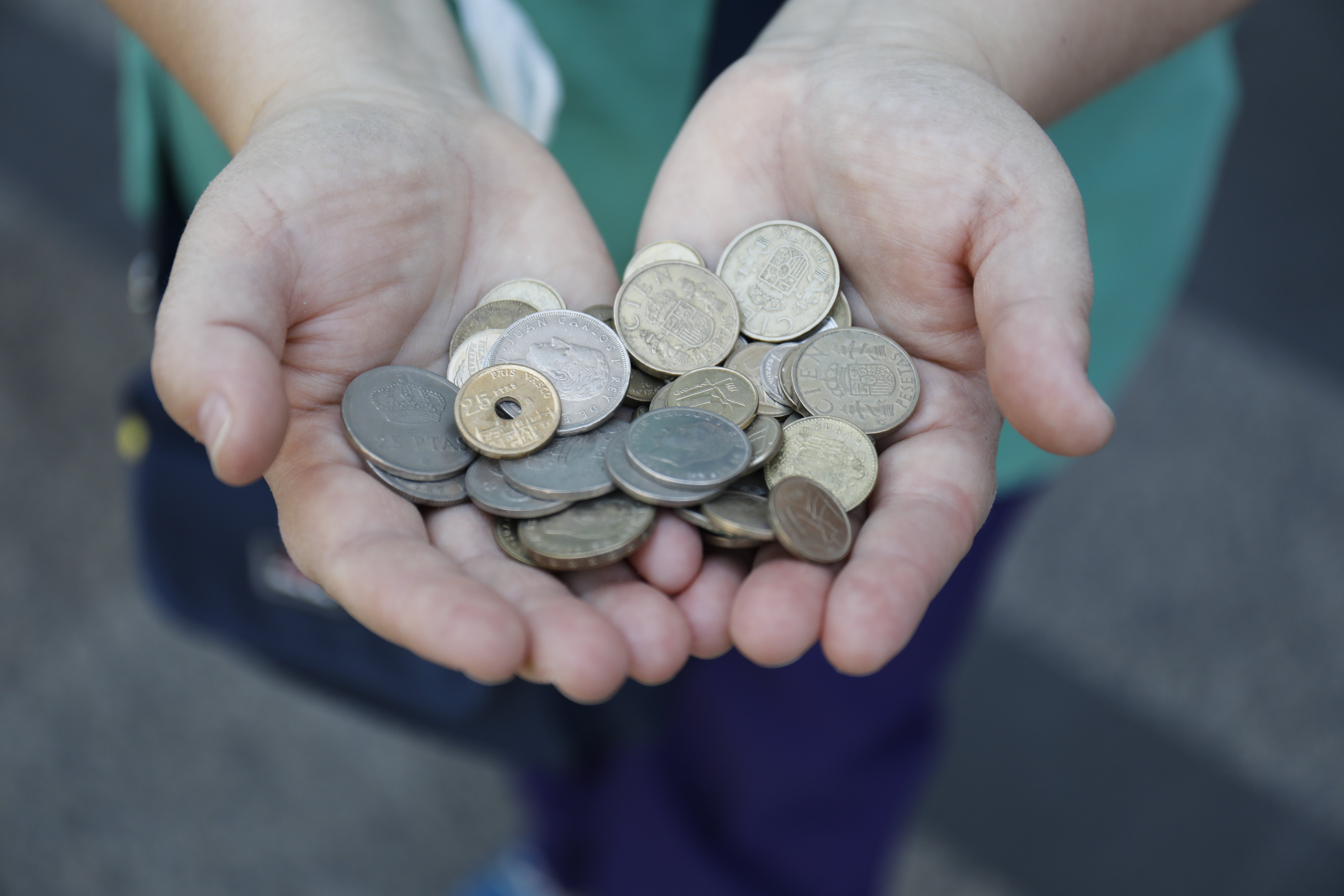 EuropaPress 3817686 persona muestra punado monedas antiguas pesetas mientras hace cola entrar
