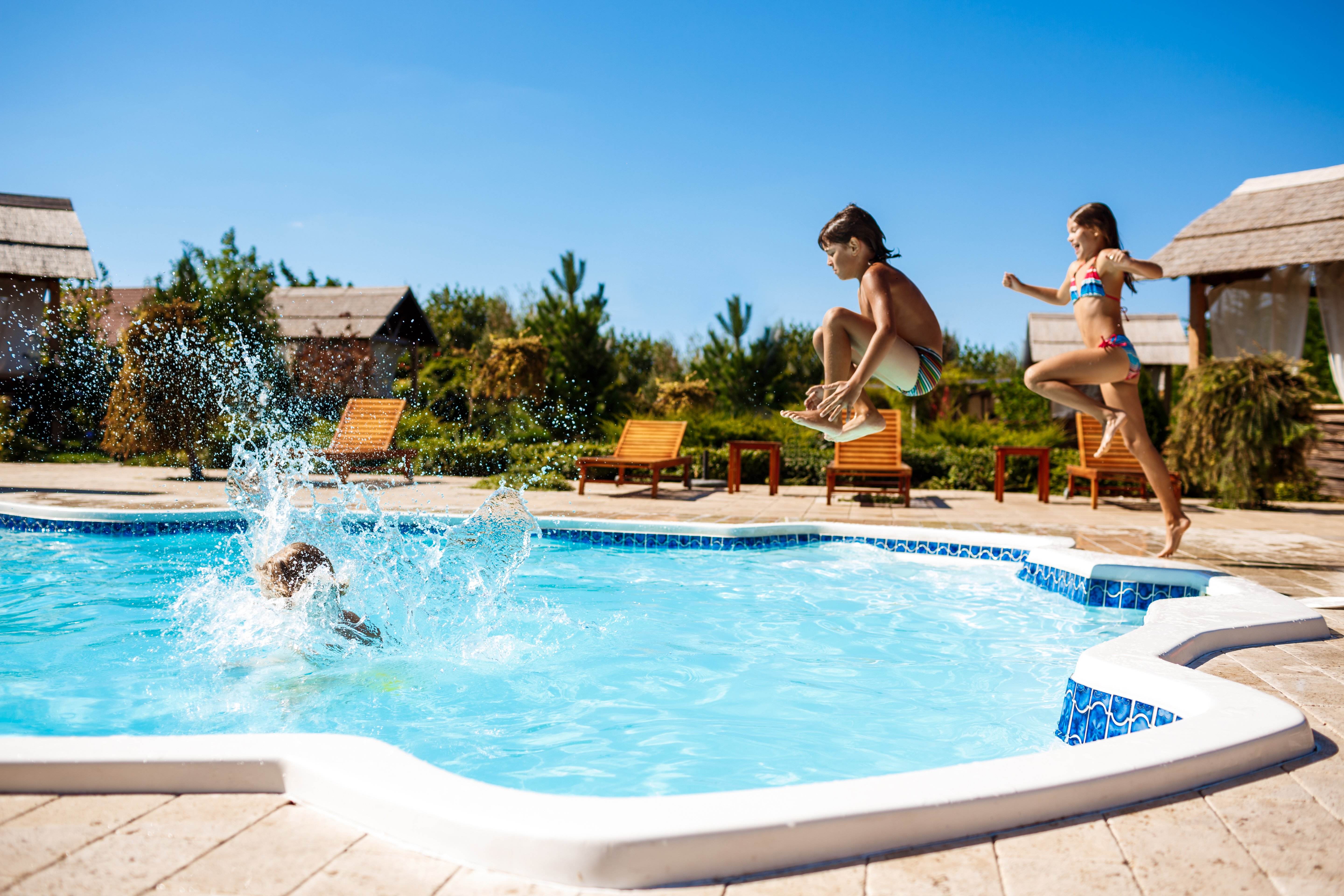 cheerful children rejoicing jumping swimming pool