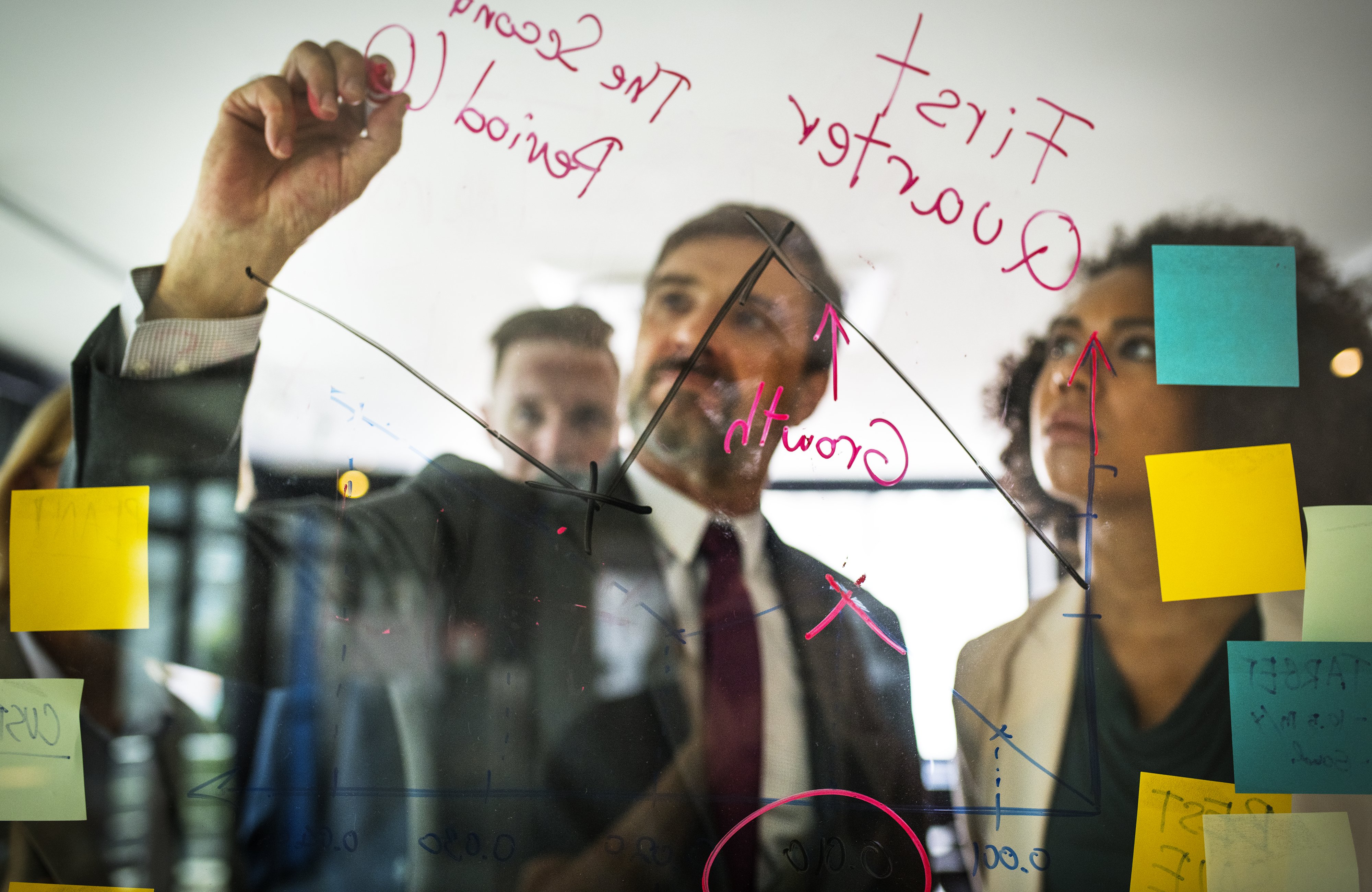 businesspeople planning glass wall