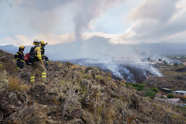 El personal de emergencias observa el avance de la lava
