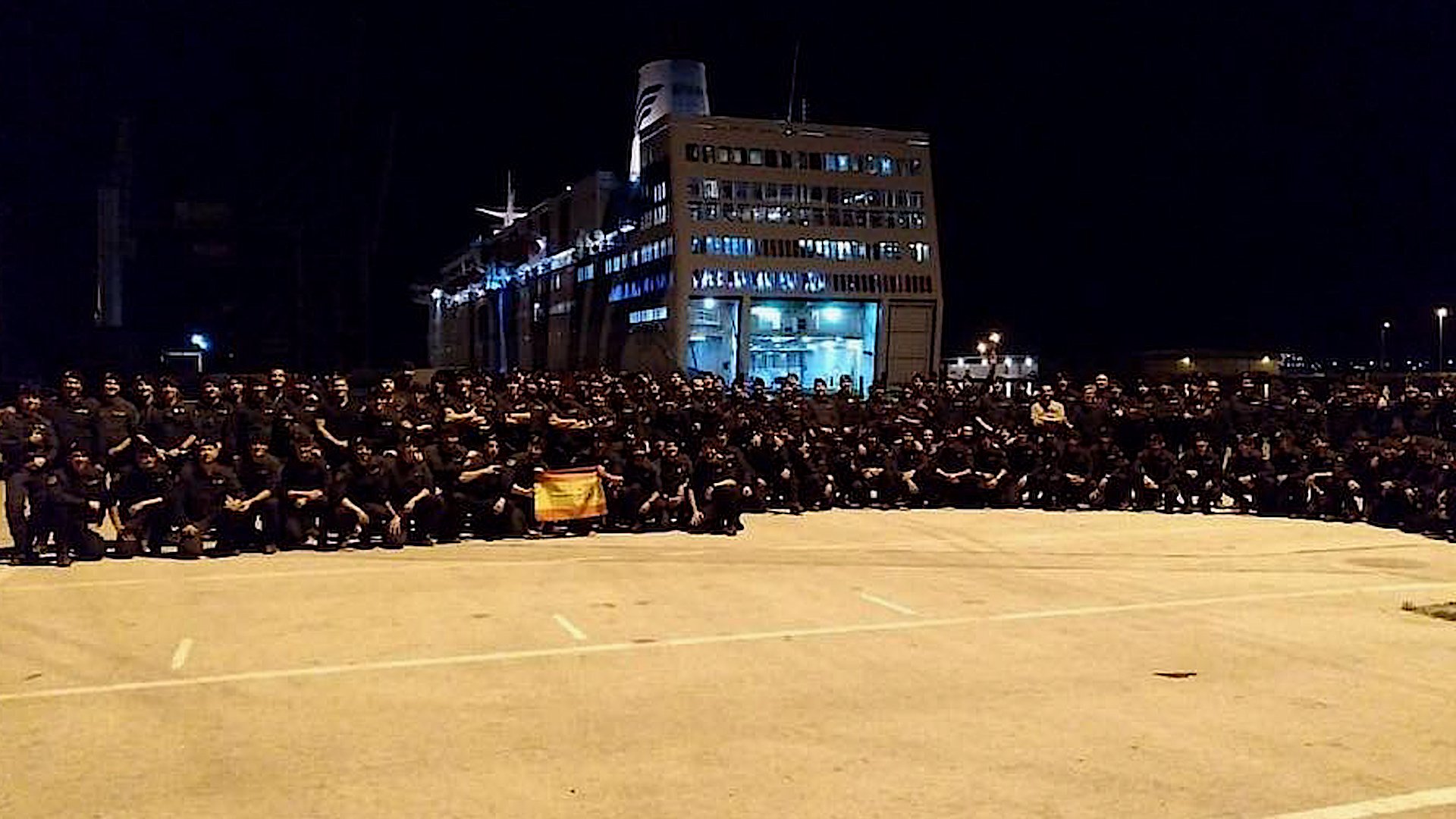 The triumphant photo of Spanish police in front of their boat