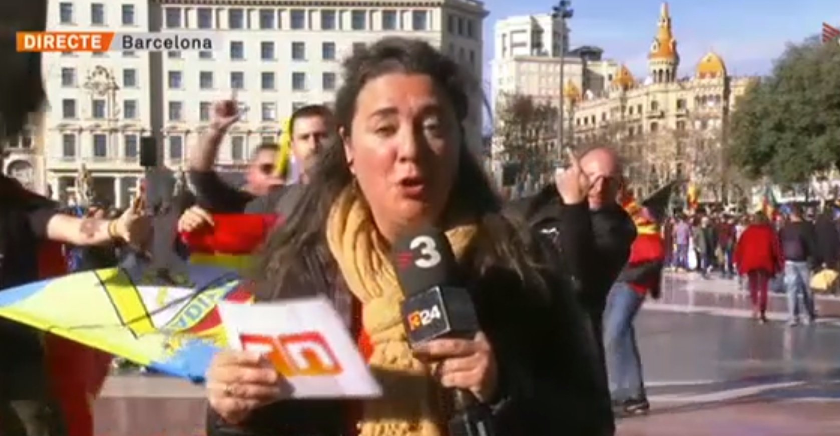 Police officers at protest interrupt Catalan newscaster