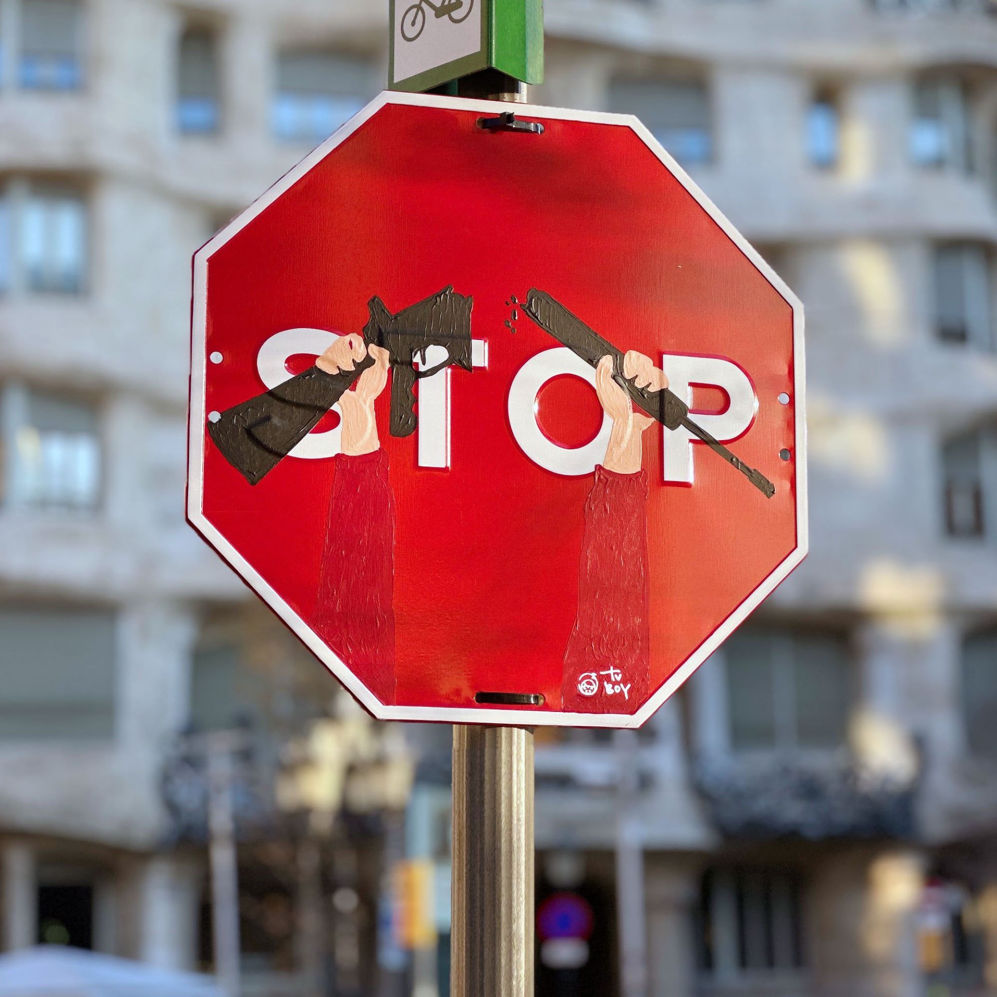 Messages of peace from Italian street artist TVBoy on Barcelona traffic signs