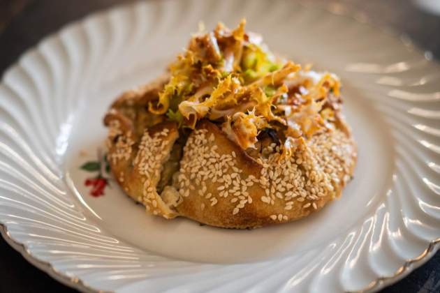 El pan de pita rellenado con queso feta y puerros|porros y acompañado de una escarola con romesco del Margarit / Foto: Marta Garreta El pan de pita rellenado con queso feta y puerros|porros y acompañado de una escarola con romesco del Margarit / Foto: Marta Garreta