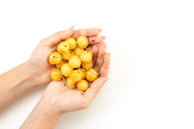top view female hòlding cherries mellow sweet fruits white fruit color summer top view female hòlding cherries mellow sweet fruits white fruit color summer