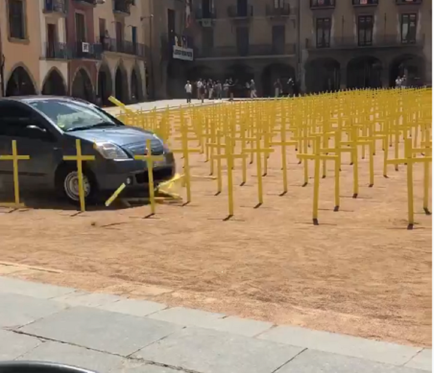 A car runs over yellow crosses in installation supporting political prisoners