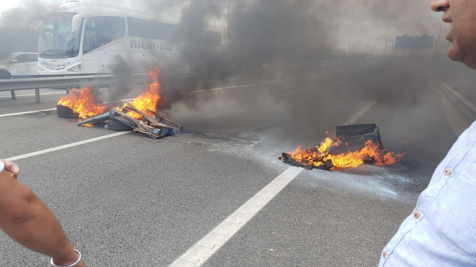 Los taxistas queman objetos en los accesos por carretera al aeropuerto del Prat